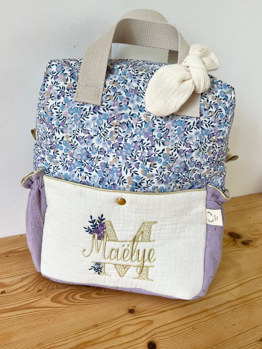 Le sac à dos enfant Ombeline poche double gaze crème et liberty wiltshire lilas